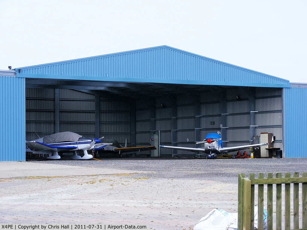 X4PE Airport - Main hangar at the Peterlee Parachute Centre based at Shotton airfield. The only aircraft I could ID is G-AZOE	 Glos Airtourer 115 which is the aircraft on the right