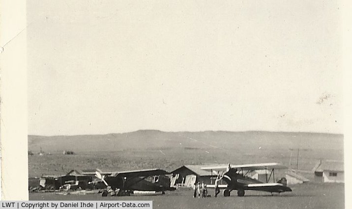 Lewistown Municipal Airport (LWT) - 1935 60 miles east of Lewistown Mt.  One penny per pound rides.  These planes landed on the ranch where my dad grew up because of the flat terrain.