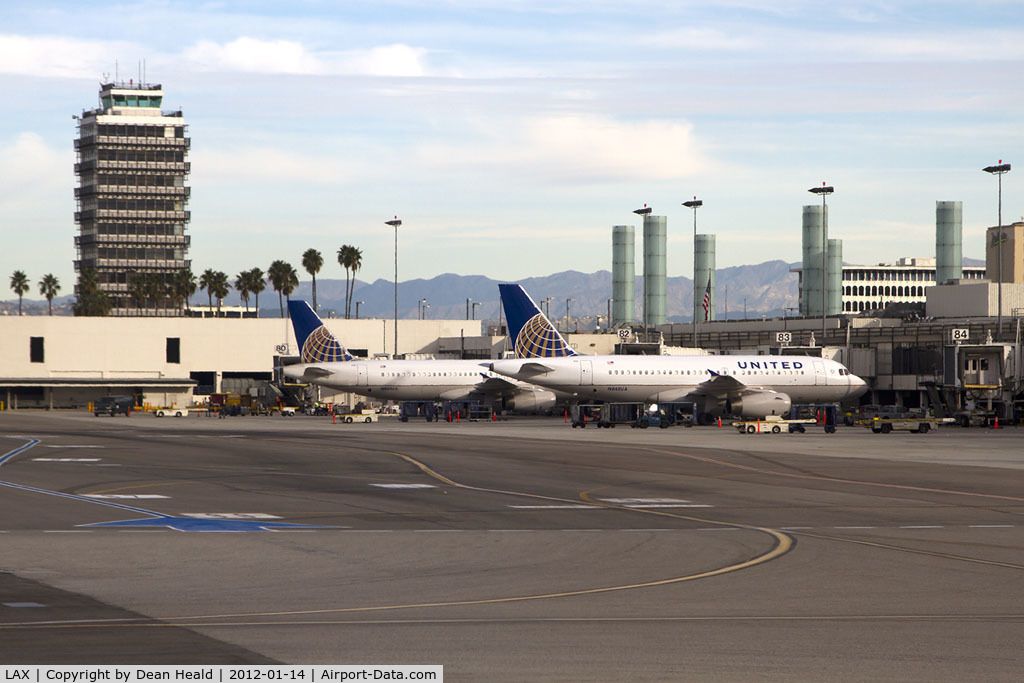 Los Angeles International Airport (LAX) - A pair of United Airlines aircraft parked at Terminal 8. The control tower on the left was in use from October 1962 to April 1996.