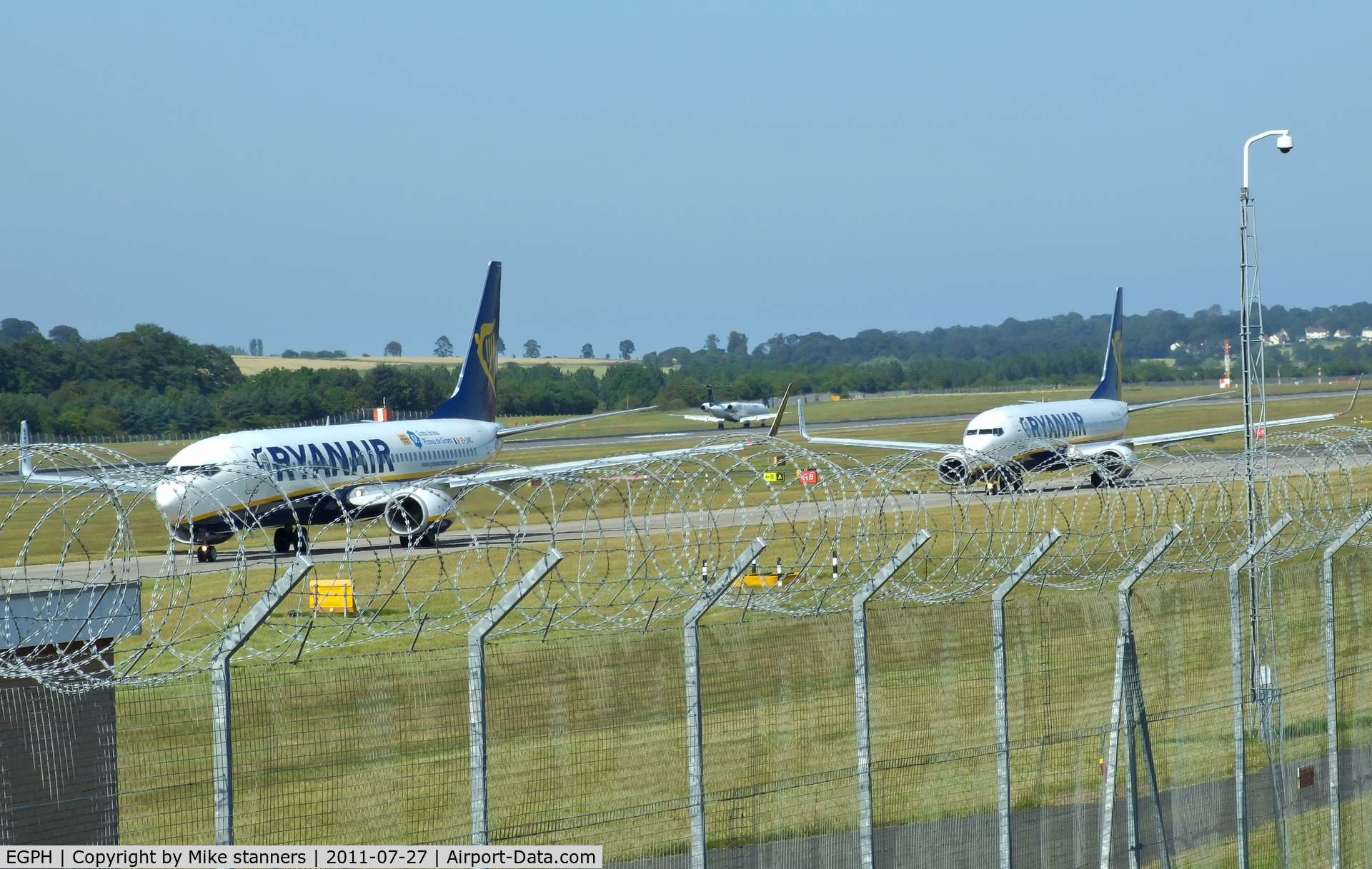 Edinburgh Airport, Edinburgh, Scotland United Kingdom (EGPH) - Ryanair B737-800's EI-DWC & EI-DAO Taxiing to runway 06,while in the back ground is G-RJXI 