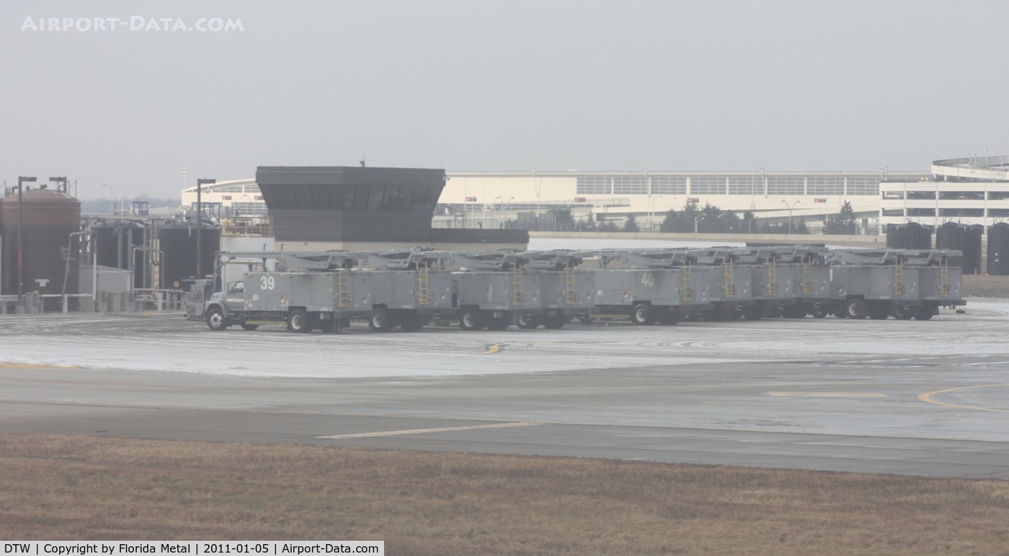 Detroit Metropolitan Wayne County Airport (DTW) - De-icing vehicles all lined up on the ramp