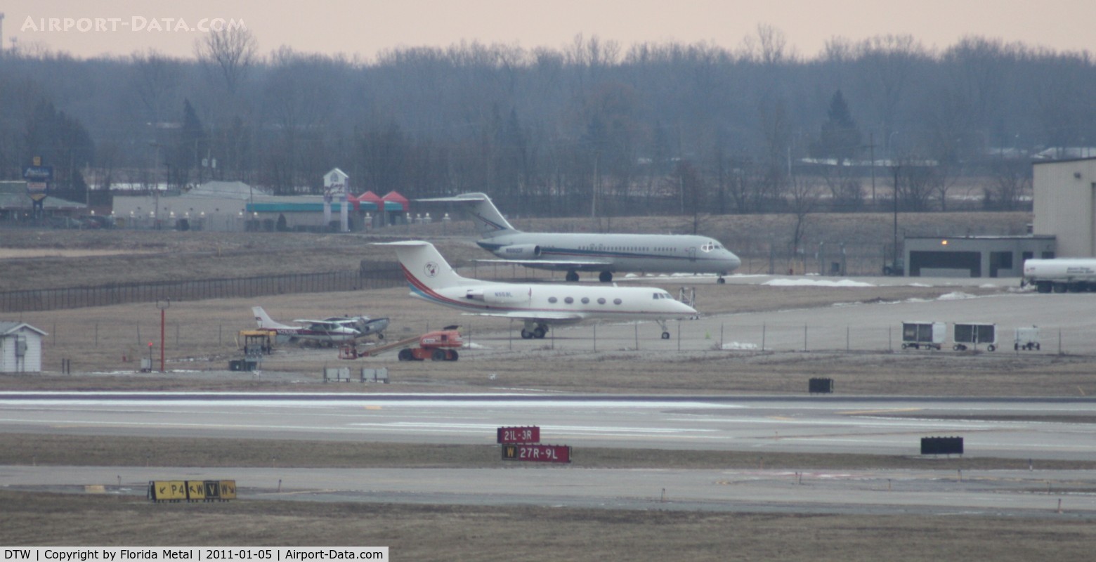 Detroit Metropolitan Wayne County Airport (DTW) - Across the ramp - Little Caesars Gulfstream II, former Detroit Pistons DC-9s, an O-2 that doesn't look flyable and a Cessna 172 - oh yeah and behind that 