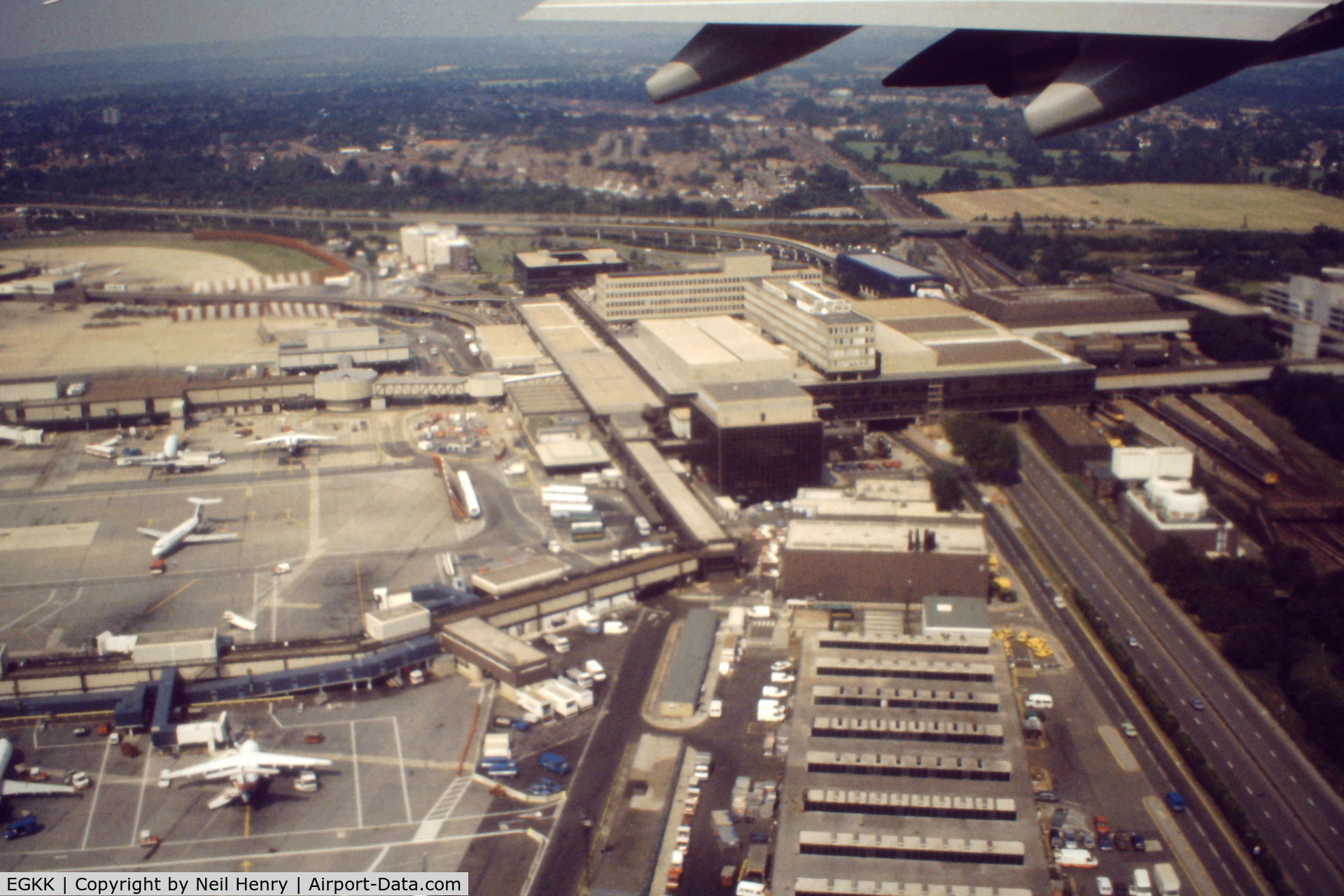 London Gatwick Airport, London, England United Kingdom (EGKK) - Scanned from original slide taken in early September 1991.  The view is of the then Terminal buildings (later to be South Terminal) and rail station, taken from departing NorthWest Airlines flight to MSP.