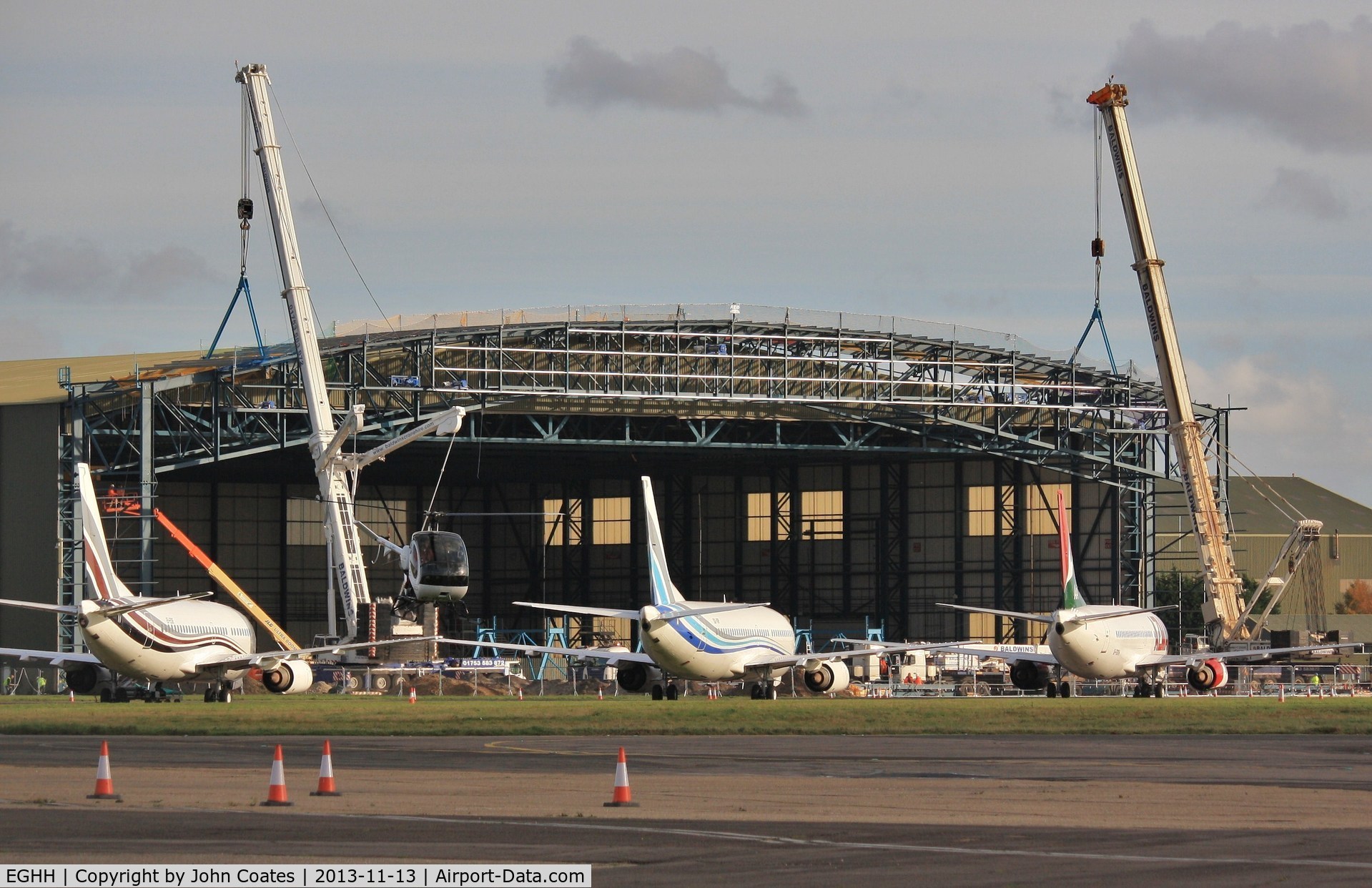 Bournemouth Airport, Bournemouth, England United Kingdom (EGHH) - Hangar extension for new B748BBJ taking shape - flyby by G-EMOL.