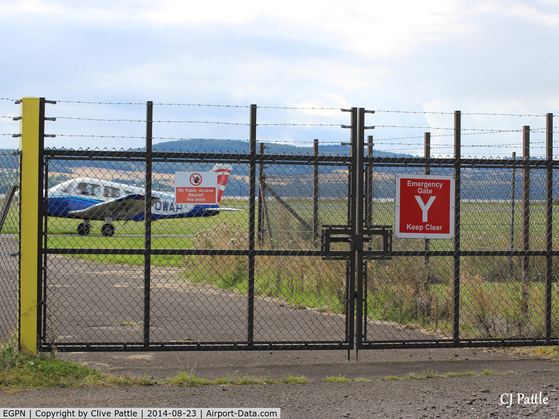 Dundee Airport, Dundee, Scotland United Kingdom (EGPN) - Crash Gate by industrial estate viewing area - take a pair of steps if you want to take photos or stick your lens thru a hole !.