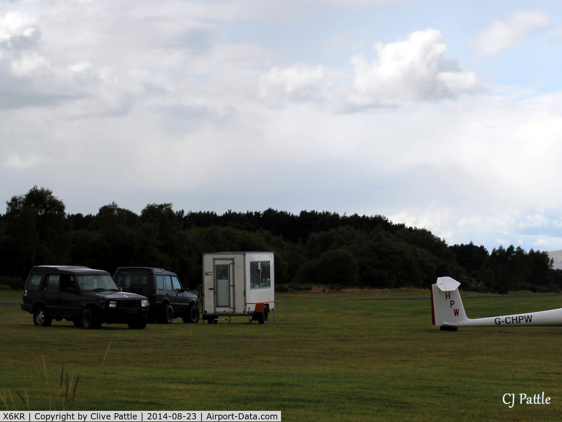 X6KR Airport - Portmoak Gliding Field, Kinross, Scotland. A view of the winch launch control cabin and two Land Rovers fitted with wide tyres for glider recovery.