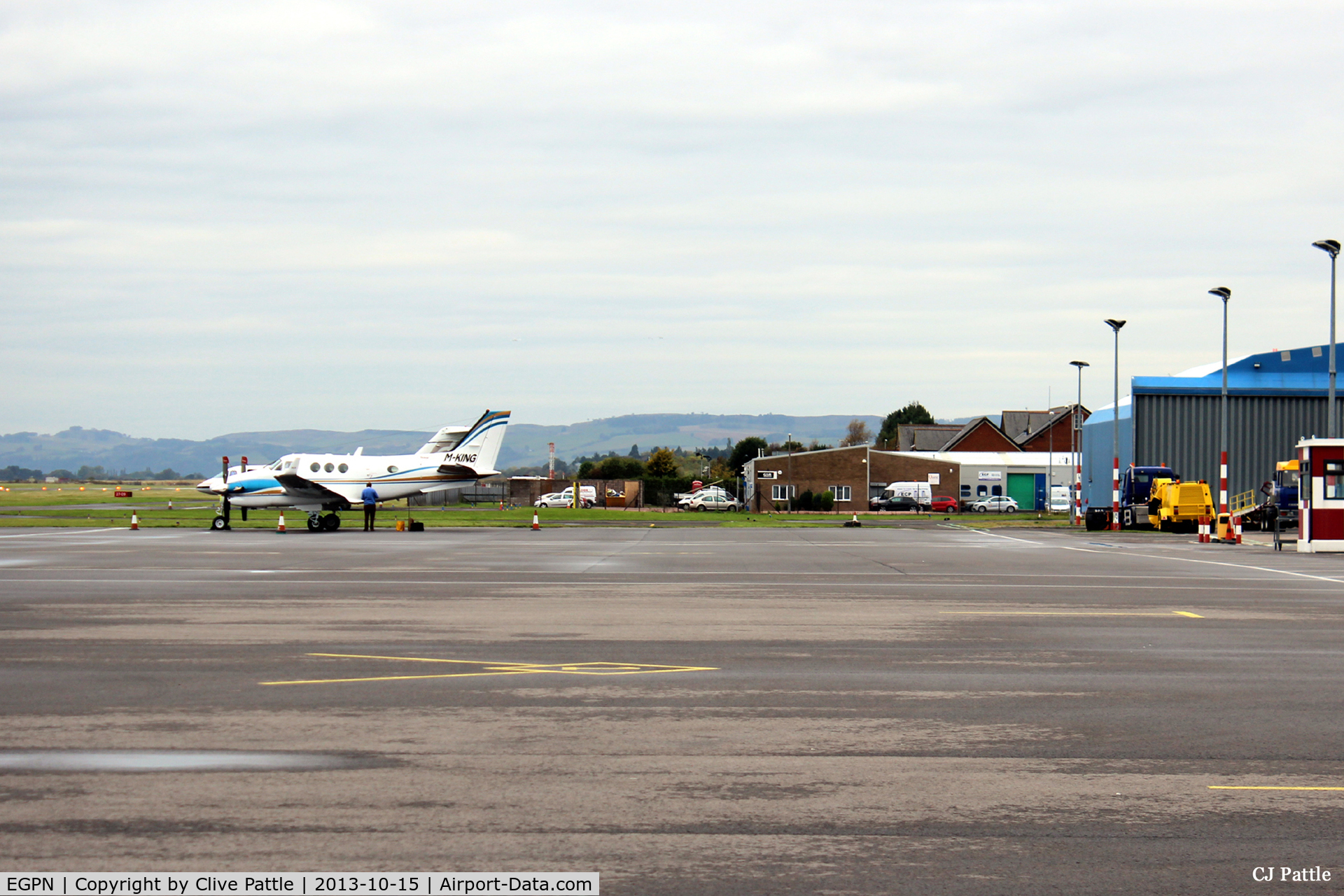 Dundee Airport, Dundee, Scotland United Kingdom (EGPN) - Wide expanse of apron available at Dundee Riverside. In the distance, looking west,  is a visiting M-KING and on the right the Loganair/Flybe maintenance hangar is visible