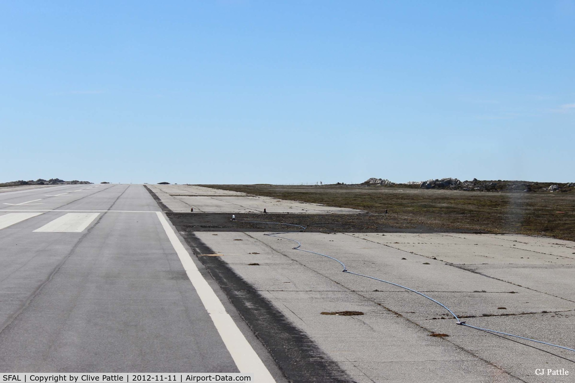 SFAL Airport - A darkened area of tarmac on the edge of the main runway at Port Stanley (SFAL) clearly shows where repairs were made following the Vulcan Black Buck bombing in May 1982. 