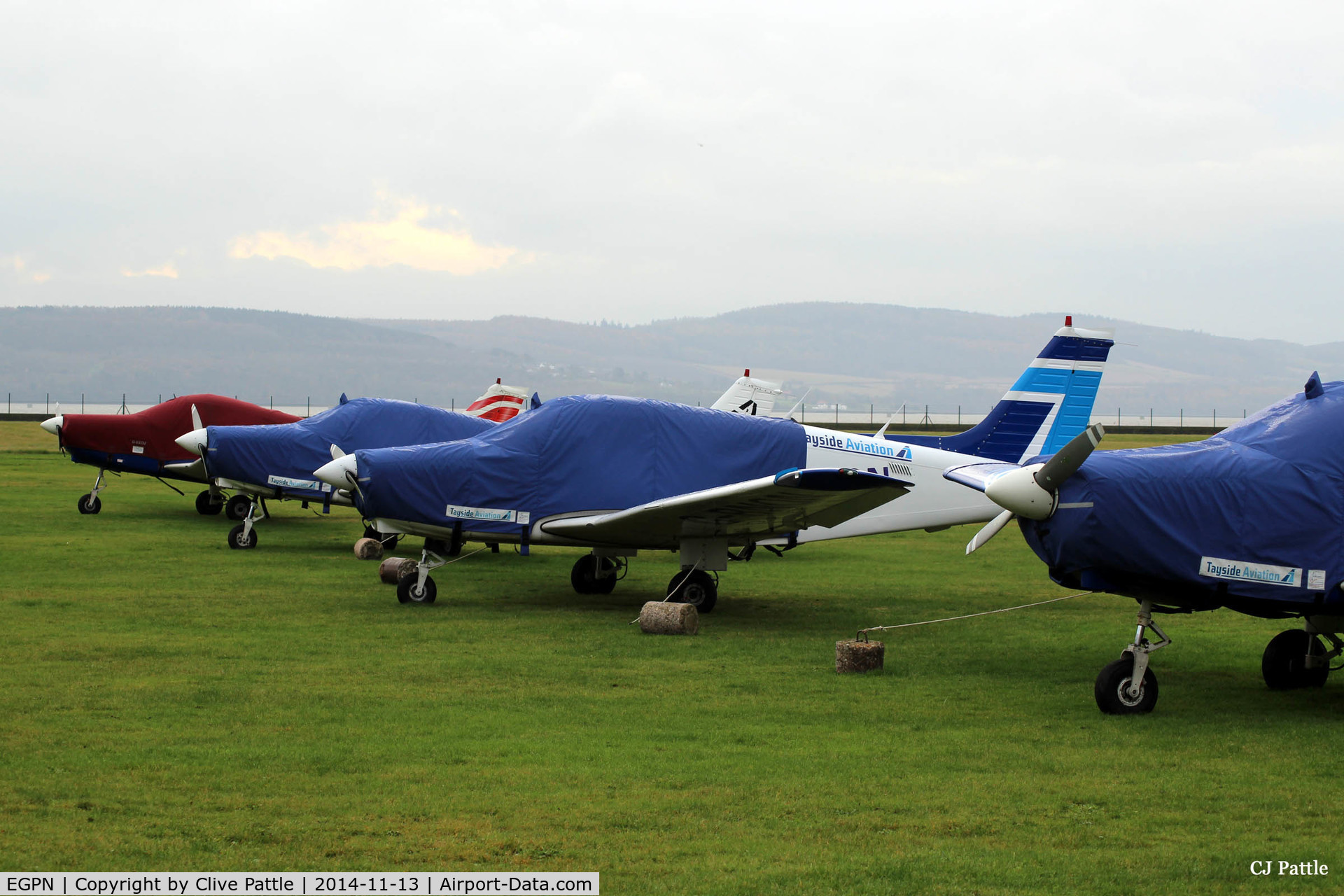 Dundee Airport, Dundee, Scotland United Kingdom (EGPN) - A line-up of PA-28's of Tayside Aviation at Dundee Riverside, wrapped in their protection for winter.