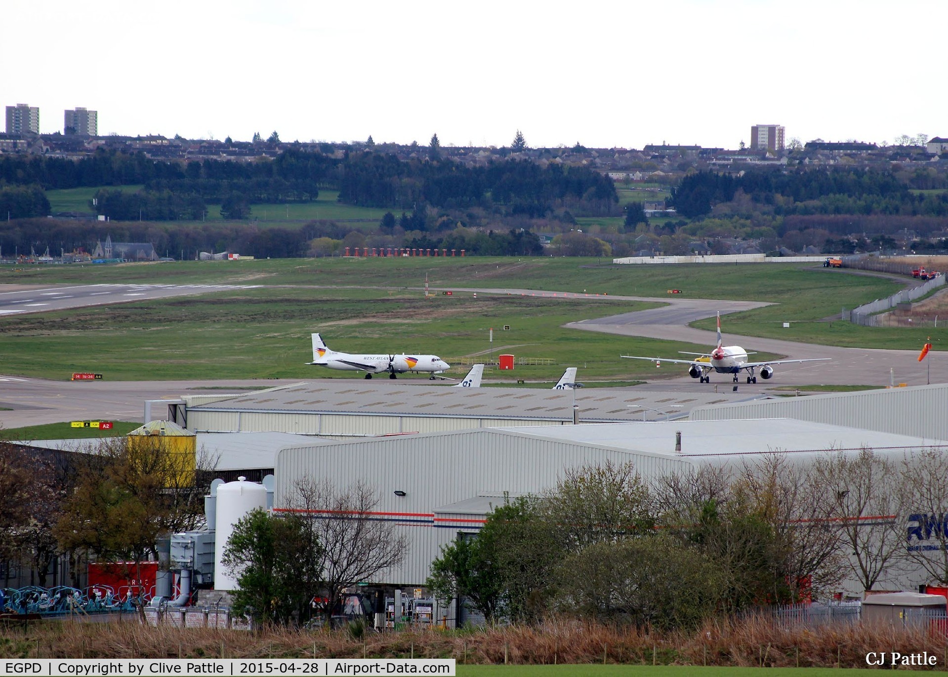 Aberdeen Airport, Aberdeen, Scotland United Kingdom (EGPD) - Looking South-Southeast across the airport at Aberdeen EGPD with a BA A320 taxying to the gate past a parked BAe ATP of West Atlantic Cargo.