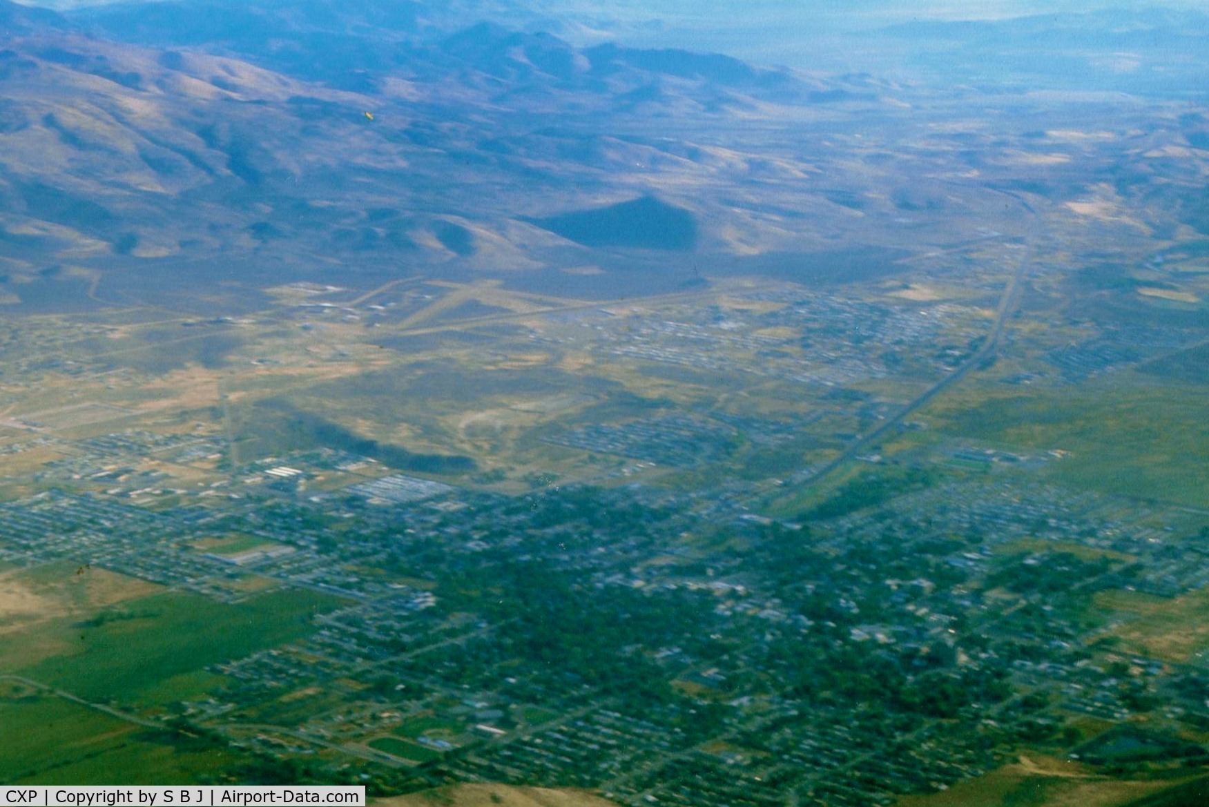 Carson Airport (CXP) - Carson City is seen near mts.Dirt crosswind runway(seen best) was welcome on one arrival with gusty 35kt winds with 5-10 seconds of dead calm mixed in .Nasty stuff but the dirt runway was perfectly aligned for my Tcraft.View is north.