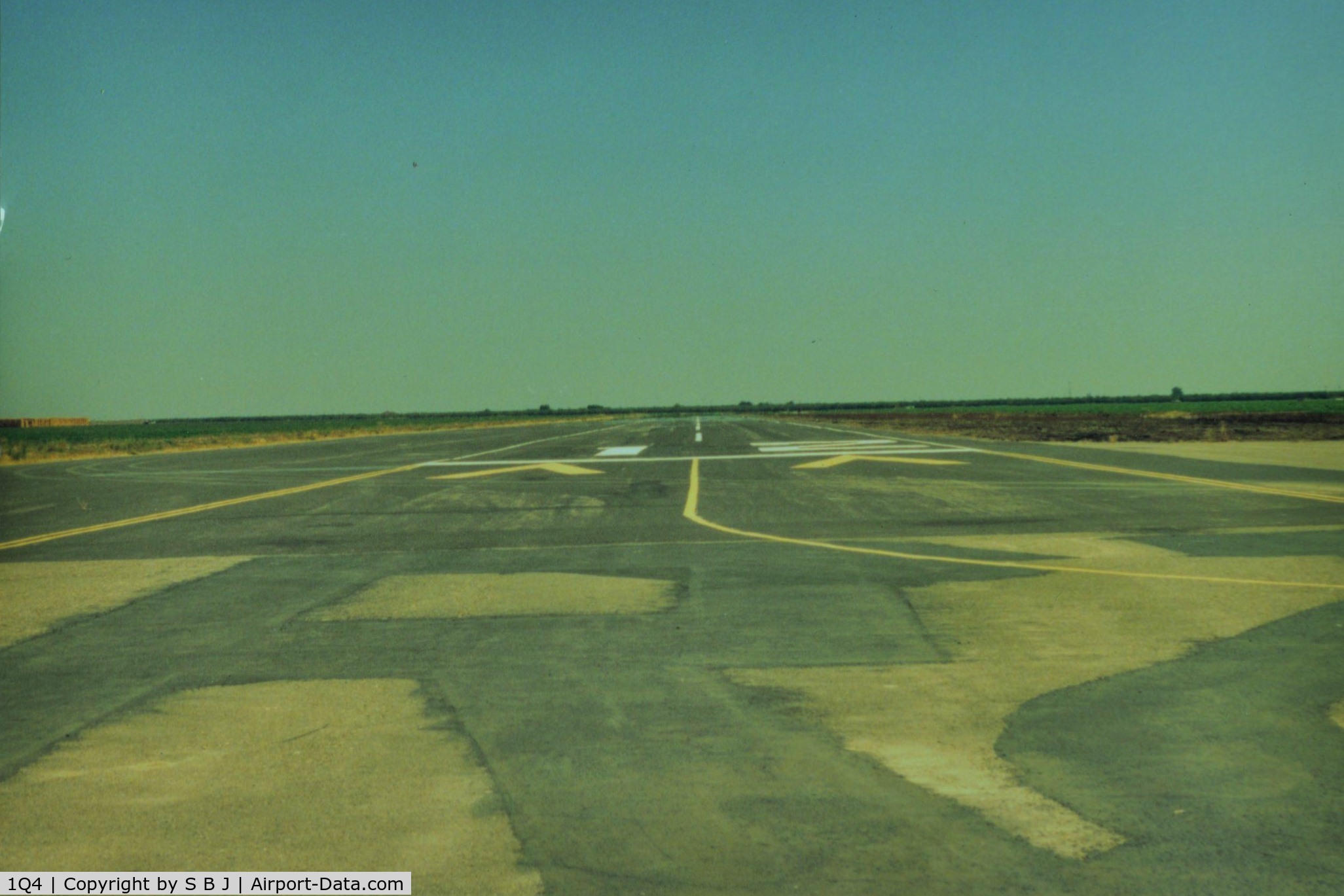 New Jerusalem Airport (1Q4) - View down runway 12.At one point the FAA said the threshold was to near an existing irrigation ditch, so airport was closed.Somebody came up with the idea of moving threshold  down 300 feet as seen. FAA happy and airport reopened.