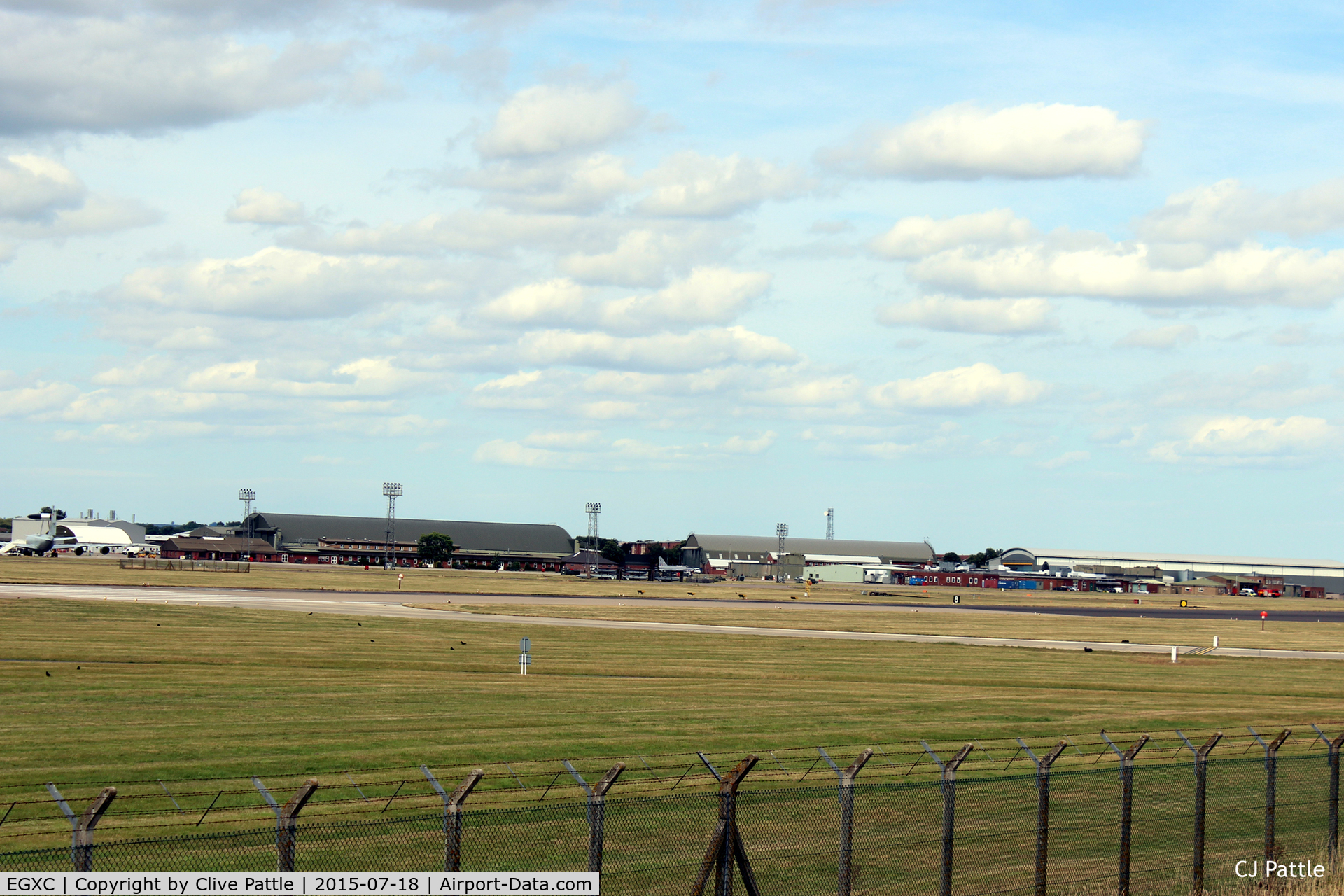 RAF Coningsby Airport, Coningsby, England United Kingdom (EGXC) - Airfield view RAF Coningsby EGXC - viewed from the south side, the 29 (R) Sqn hangar and buildings. The 'Gate Guard' English Electric Lightning can be seen mid image. 