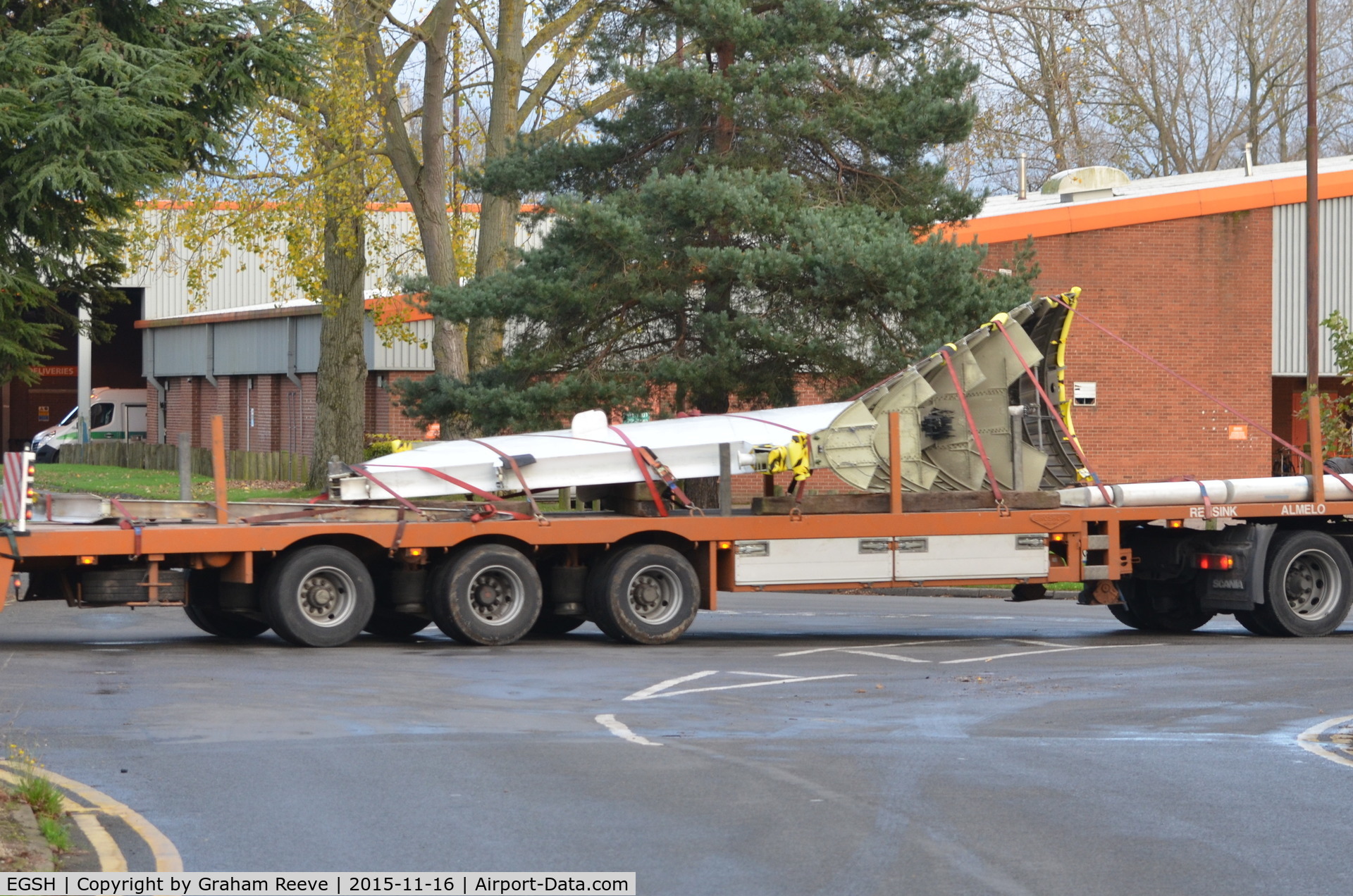 Norwich International Airport, Norwich, England United Kingdom (EGSH) - F70 tail leaving Norwich (via main gate) on a low loader.