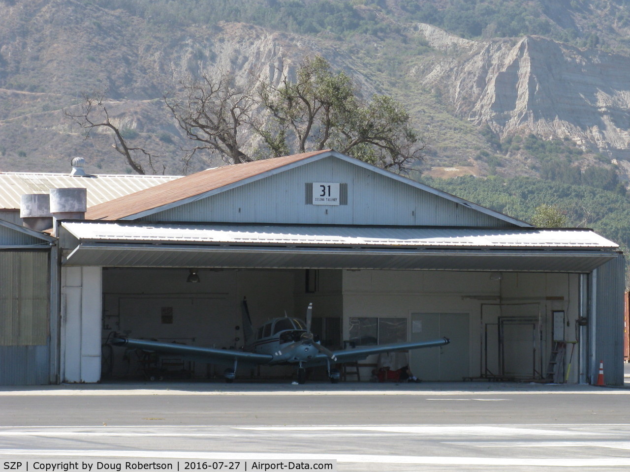 Santa Paula Airport (SZP) - Santa Paula Airport Do-It-Yourself Aircraft Paint Facility. Rare to see doors open, some masking of a Piper PA-28 is being done, and it is already hot mid-morning.