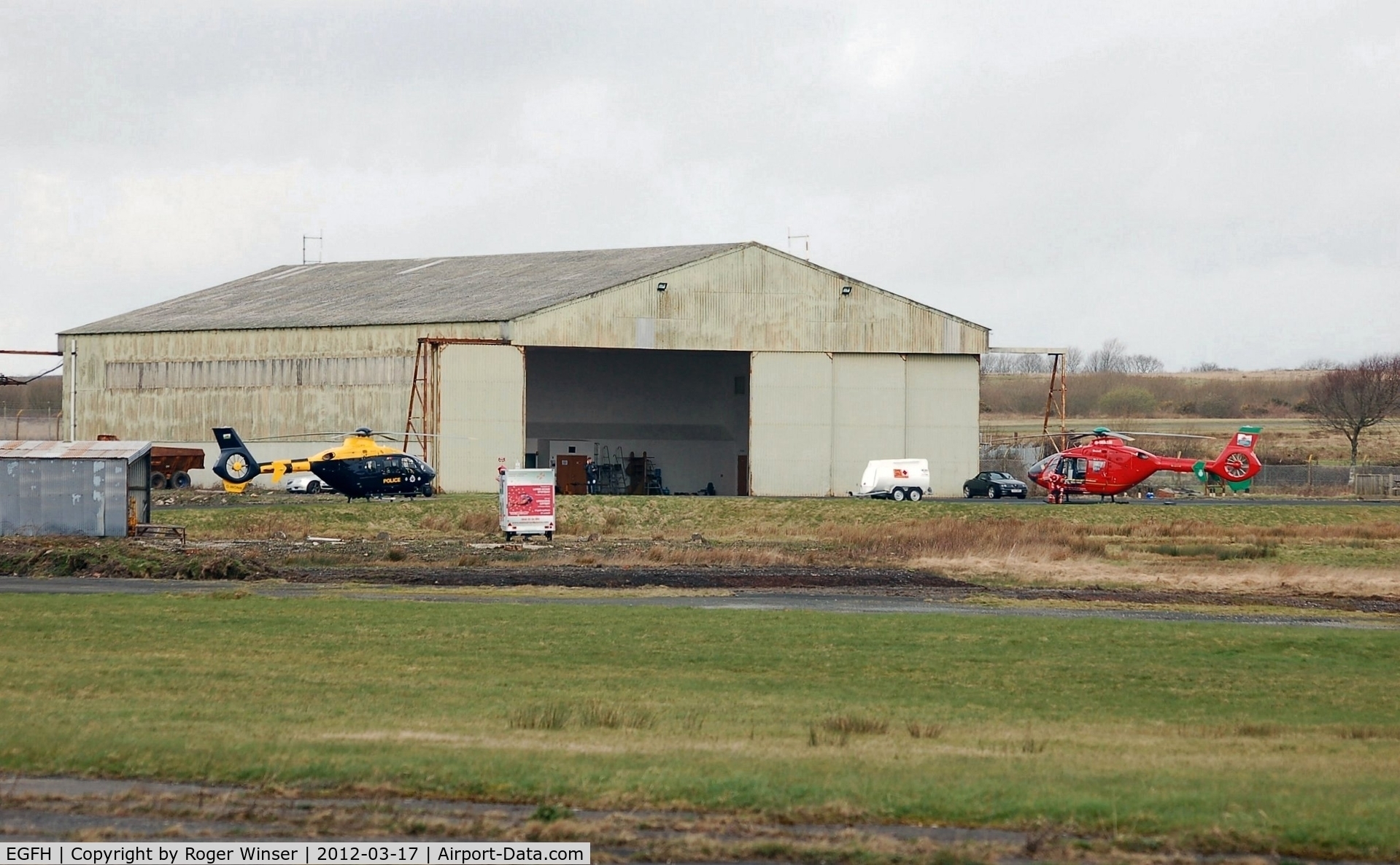 Swansea Airport, Swansea, Wales United Kingdom (EGFH) - Emergency services (police and air ambulance) helicopters at the Wales Air Ambulance base in Hangar 1.