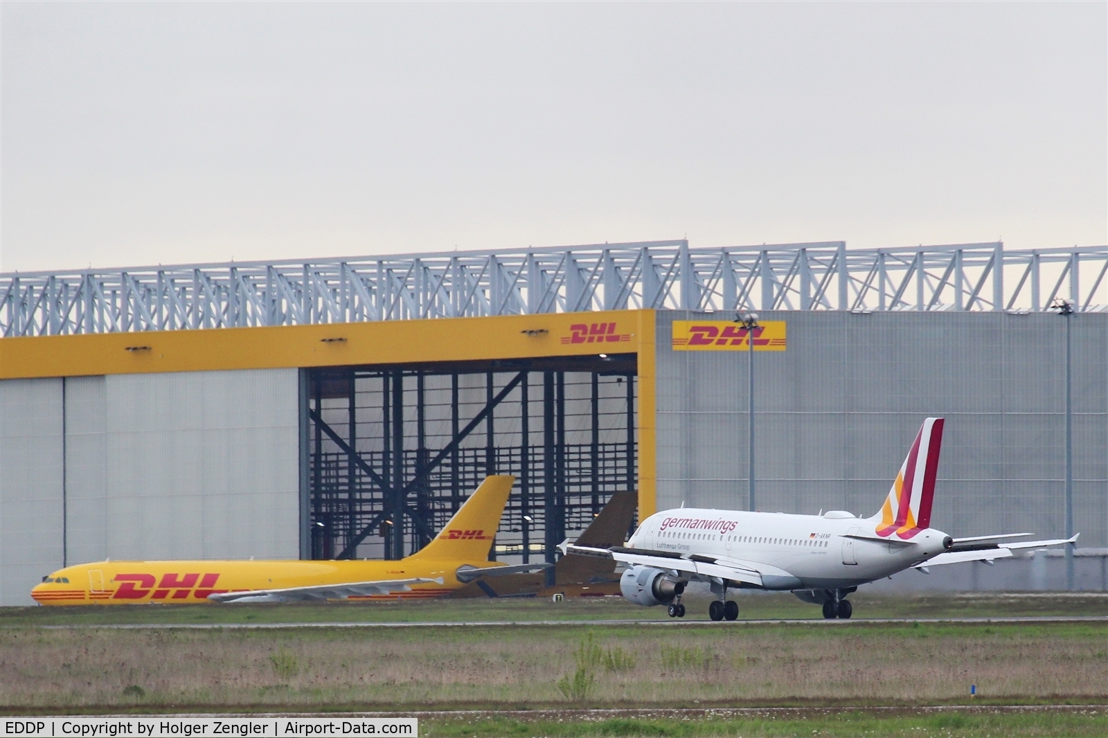 Leipzig/Halle Airport, Leipzig/Halle Germany (EDDP) - Inbound traffic on rwy 08R passes DHL parcel freighter .....