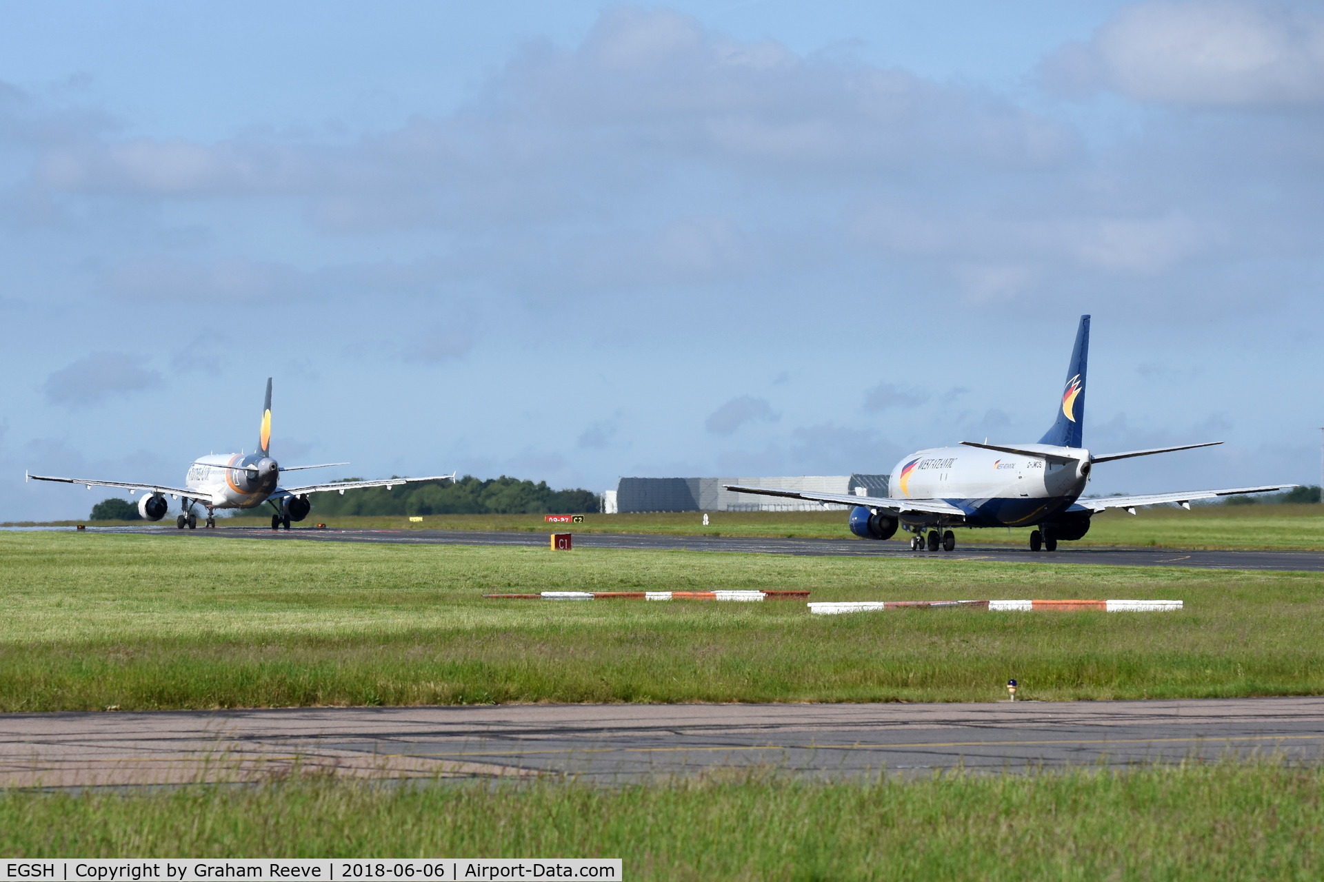 Norwich International Airport, Norwich, England United Kingdom (EGSH) - YL-LCO and G-JMCS both on taxiway Charlie.