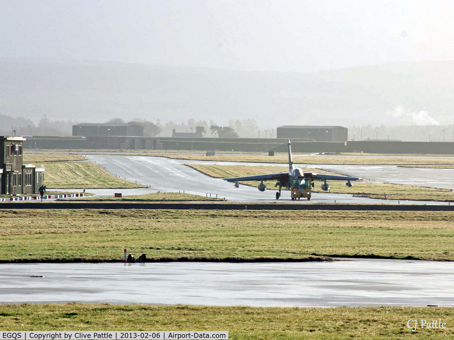 RAF Lossiemouth Airport, Lossiemouth, Scotland United Kingdom (EGQS) - The sunshine after the rain - A Tornado GR4 is towed across the airfield