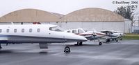 Burlington-alamance Regional Airport (BUY) - Rainy day, but a nice, tight lineup on the ramp - by Paul Perry