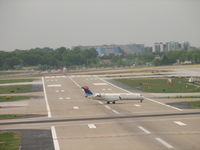 Lambert-st Louis International Airport (STL) - Taxiing to the terminal shot this bombardier crossing RWY6 - by Sam Andrews