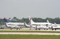 Daytona Beach International Airport (DAB) - Delta aircraft arrives in background of a big group of parked planes for the race - by Florida Metal