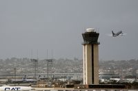 San Diego International Airport (SAN) - United plane passes tower - by Chuck Martinez