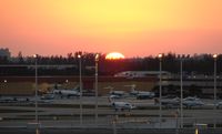 Fort Lauderdale/hollywood International Airport (FLL) - The sunsets over the busy FBO during Miami Boat Show Week - by Terry Fletcher