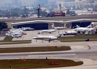 Fort Lauderdale/hollywood International Airport (FLL) - The landing aircraft passes an already busy FBO at FLL - by Terry Fletcher