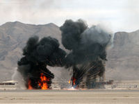 Nellis Afb Airport (LSV) - Nellis AFB ATCT with smoke and fire from mock wargames. Aviation Nation 2007 - by Brad Campbell