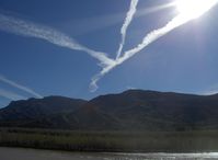 Santa Paula Airport (SZP) - Three jet contrails converging over Fillmore VORTAC FIM near SZP, South Mountain in background. Santa Clara River flowing from snowmelt and rain at base of photo. - by Doug Robertson