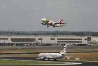 Brussels Airport, Brussels / Zaventem   Belgium (EBBR) - flight TP605 (A319-111 - CS-TTB) is taking off from rwy 20.  In background is Pier B - Non-Schengen terminal. - by Daniel Vanderauwera