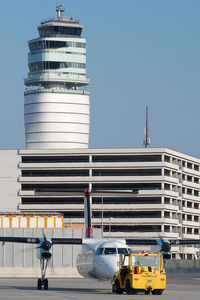 Vienna International Airport, Vienna Austria (VIE) - Dash 8 pushing back in front of ATC tower - by Yakfreak - VAP