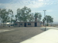 Needles Airport (EED) - Terminal Bldg. Phone to Riverside FSS, toilets and flight-planning tables - by Doug Robertson