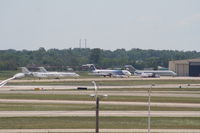 Detroit Metropolitan Wayne County Airport (DTW) - Looking across Runways 3R/21L and 3L/21R at an ex Spirit MD80, Detroit Pistons DC-9 and several private jets - by Florida Metal