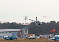 Blackbushe Airport, Camberley, England United Kingdom (EGLK) - LOOKING FROM THE AIRFIELD NORTH SIDE TOWARDS THE TERMINAL WITH ROLLASON R22 G-BZYE DEPARTING NORTH - by BIKE PILOT