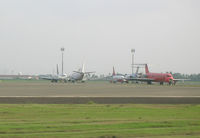 Soekarno-Hatta International Airport, Cengkareng, Banten (near Jakarta) Indonesia (WIII) - Many aircraft in need of repair at Jakarta - by John J. Boling