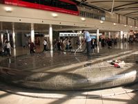 Detroit Metropolitan Wayne County Airport (DTW) - Cleaning up the coins on the fountain in the McNamara terminal - by Timothy Aanerud