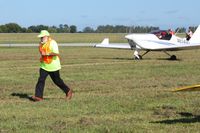 Grimes Field Airport (I74) - Sam hustling to park a plane at the MERFI fly-in. - by Bob Simmermon