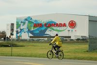 Vancouver International Airport, Vancouver, British Columbia Canada (YVR) - The Air Canada hangar at YVR with  Vancouver 2010  Olympics  decoration.Note the two spotters on the left - by metricbolt