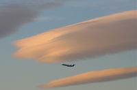 Los Angeles International Airport (LAX) - America West CRJ departing 24L KLAX with some lenticular clouds overhead. - by Mark Kalfas