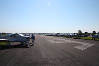 Fond Du Lac County Airport (FLD) - Looking east down RWY 9 as temporary parking ramp during Oshkosh 2010. - by Bob Simmermon