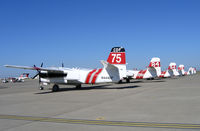Mc Clellan Airfield Airport (MCC) - CAL FIRE/CDF S-2T and TS-2A tankers on ramp just prior to start of 2005 fire season (last year piston TS-2As in service) - by Steve Nation