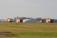 Manchester Airport, Manchester, England United Kingdom (EGCC) - Fire trucks racing down the runway after Thomas Cook B767 G-DAJC, which made an emergency landing with a problem with its flaps - by Chris Hall