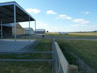 Kyneton Airport, Kyneton, Victoria Australia (YKTN) - Kyneton Aero Club Hangars and parking area looking north. The sealed strip can just be seen to the right. - by red750