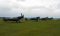 Duxford Airport, Cambridge, England United Kingdom (EGSU) - SPITFIRES ON THE FLIGHTLINE ON A VERY DULL AND RAINY DAY. - by Martin Browne
