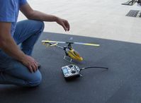 Santa Paula Airport (SZP) - T-REX radio-controlled helicopter with control/transmitter unit and remote pilot. (you learn to fly/control this helicopter on a PC simulator program, and control unit records cumulative hours of flight, etc) - by Doug Robertson