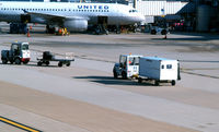 Ronald Reagan Washington National Airport (DCA) - Tug #65 with baggage cart on the ramp - by Ronald Barker