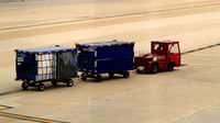 Ronald Reagan Washington National Airport (DCA) - Tug 59045 with two baggage carts - by Ronald Barker