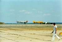 Quonset State Airport (OQU) - North America AT-6 Texan N6984C and North American AT-6 Texan 51-14987 at Quonset State Airport, North Kingstown, RI - circa 1980's - by scotch-canadian